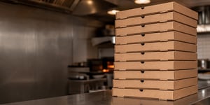 Stack Of Pizza Delivery Boxes In Kitchen